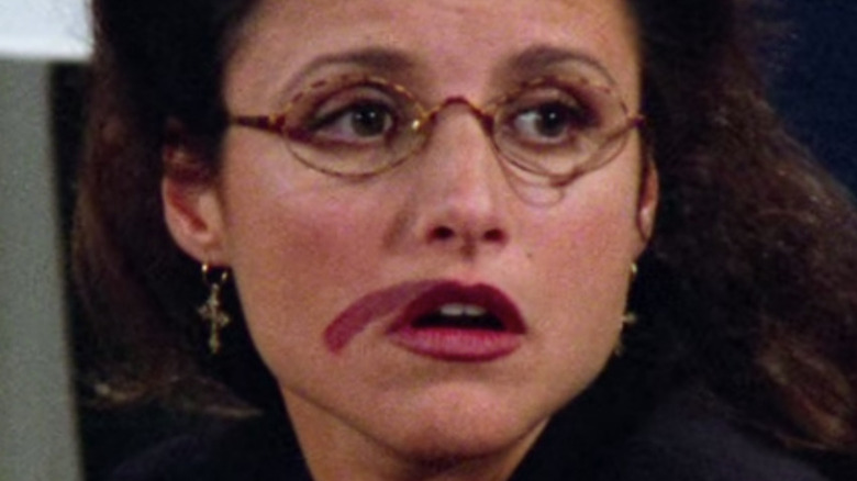 Elaine putting on lipstick