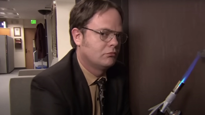 Dwight using a blowtorch