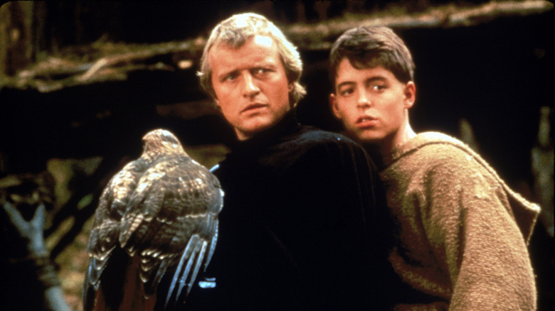 The Mouse, Isabeau and Navarre sit on a horse together in "Ladyhawke"