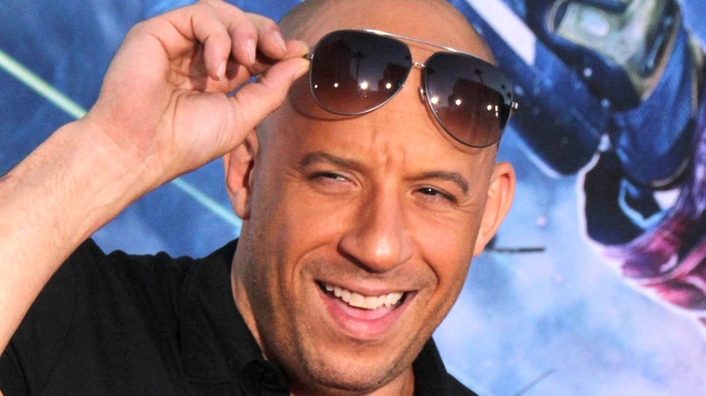 Vin Diesel looking out beneath raised sunglasses