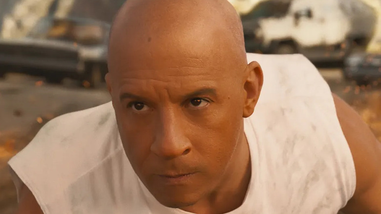 Dominic Toretto amid car wreckage
