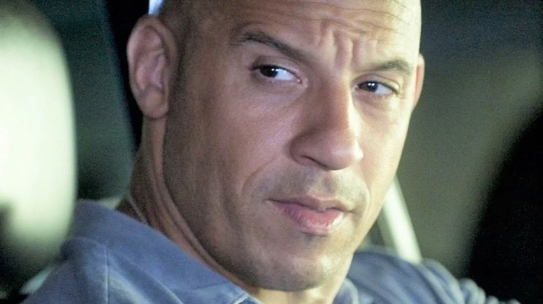 Vin Diesel sitting behind the wheel in the Fast and Furious movies