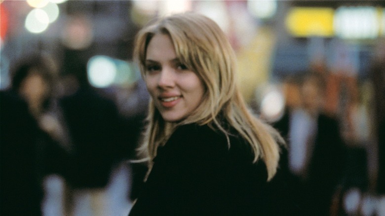Charlotte In Japan looking back smiling in Lost in Translation