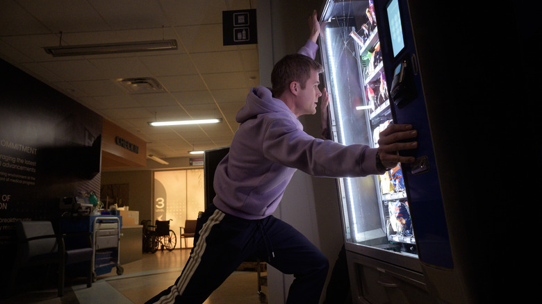 Bobby holding up vending machine
