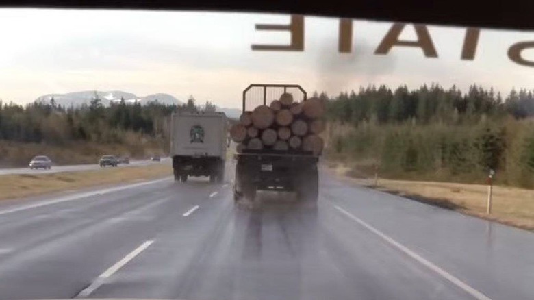 A cop driving behind the log truck in Final Destination 2