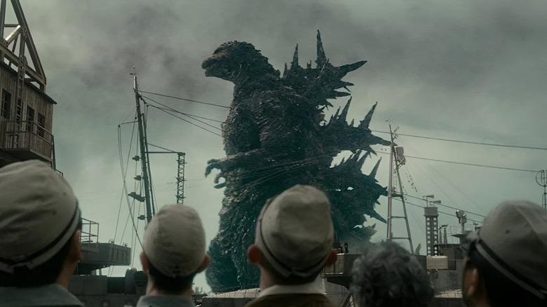 People looking up at Godzilla passing by in Godzilla Minus One