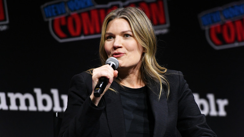 Emma Tammi at event speaking microphone