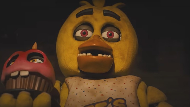 Chica holding cupcake