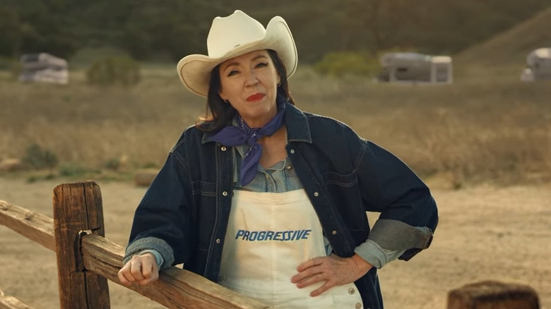Stephanie Courtney dressed up like Flo who's dressed up like a ranch hand in a Progressive ad