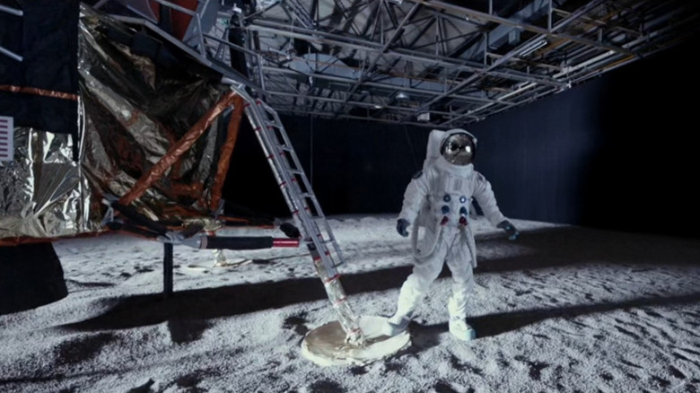 An astronaut on a fake moon set in "Moonwalkers" (2015)