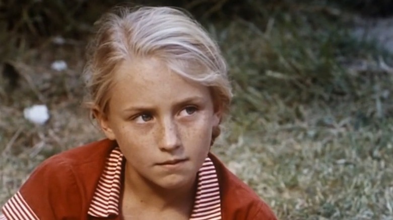 Celia looking to her left with stern expression in Celia