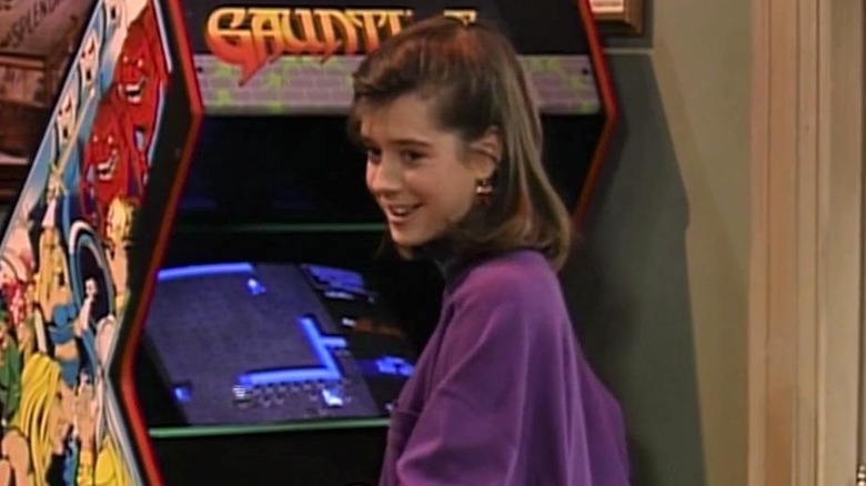 A girl playing an arcade game in "Free Spirit"