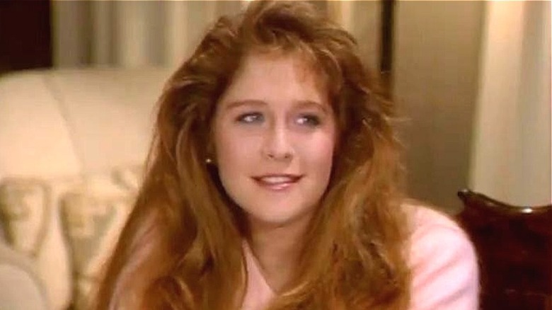 Cindy sitting on the sofa in "Just the Ten of Us"