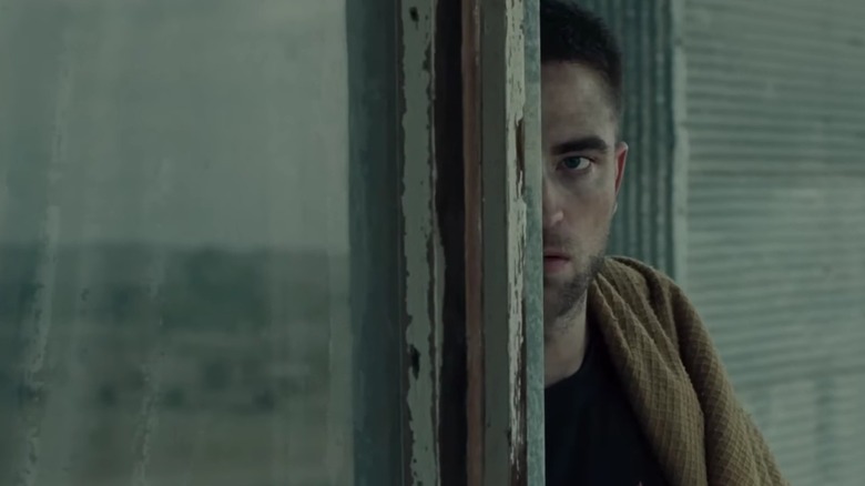 Reynolds peering around a wall in The Rover