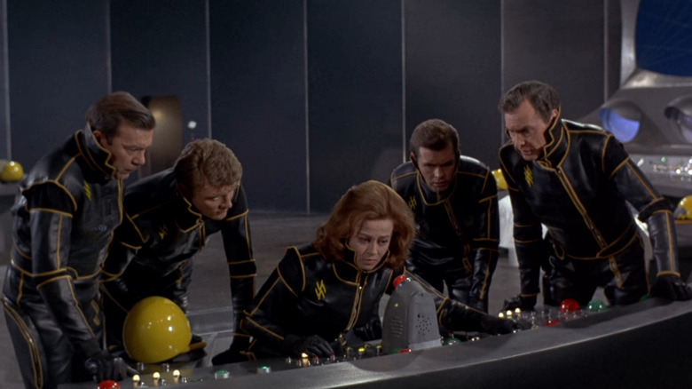Ship crew surrounding console in distress