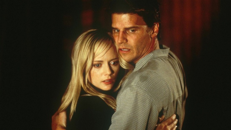 Kate Davies and Adam Carr clinging onto each other in Valentine