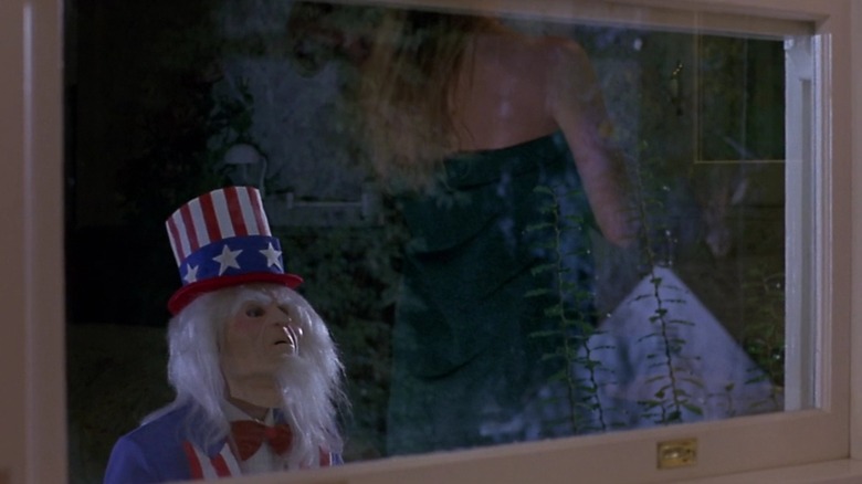 Sam peering in the window of a woman who is wrapped in a towel in "Uncle Sam"