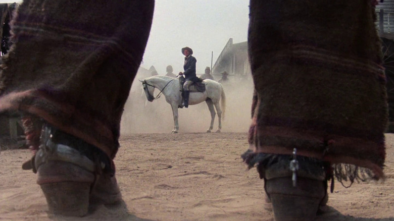 Donald O'Brien as Caldwell shot between Keoma's legs