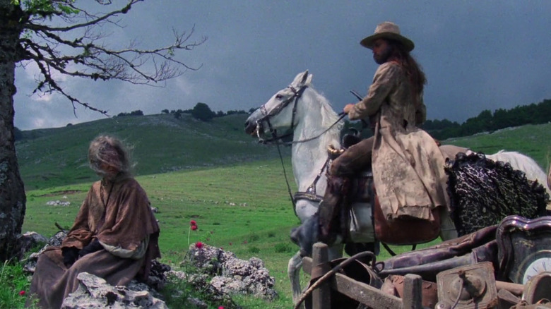 Keoma on a horse looking at the witch