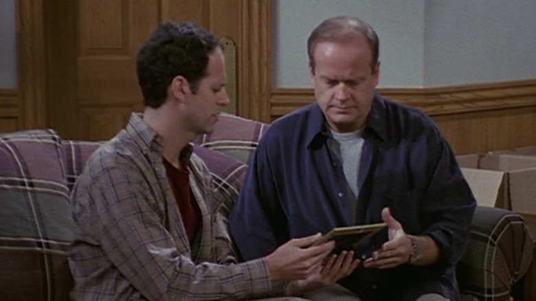 Frasier looks at a photo with Phillip