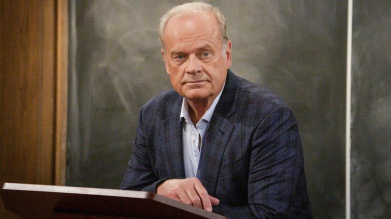 Frasier moping behind lectern