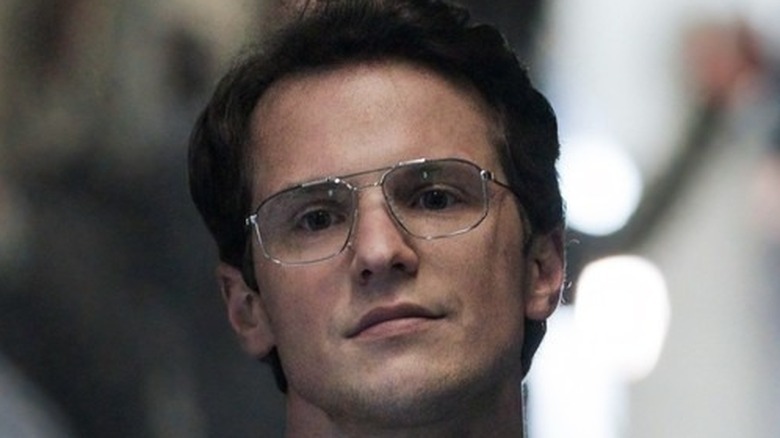 Freddie Stroma wearing glasses in "Peacemaker"