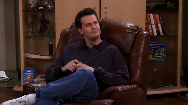 Chandler sitting in an arm chair