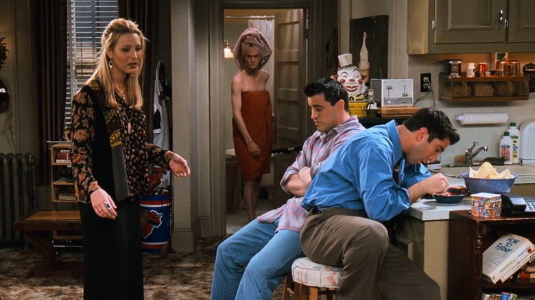 Chandler Bing coming out of bathroom in a towel to face Phoebe, Joey, and Ross in "Friends"
