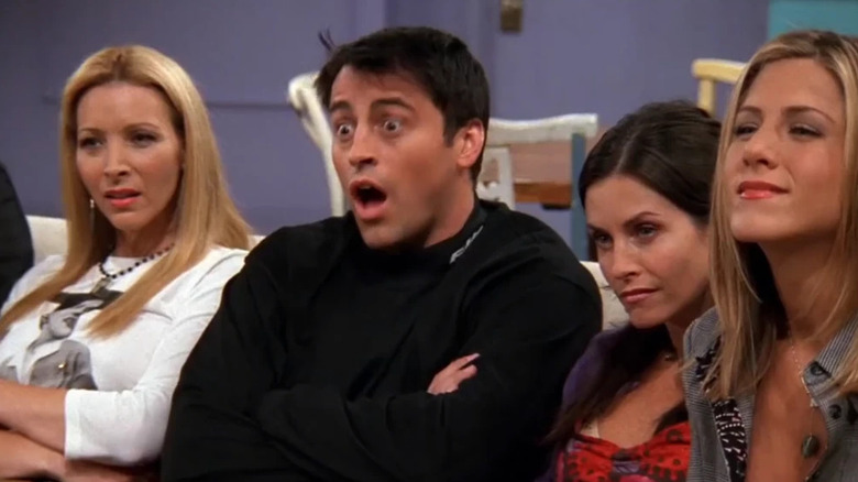 Phoebe, Joey (who is agape), Monica, and Rachel all reacting to a videotape in Friends