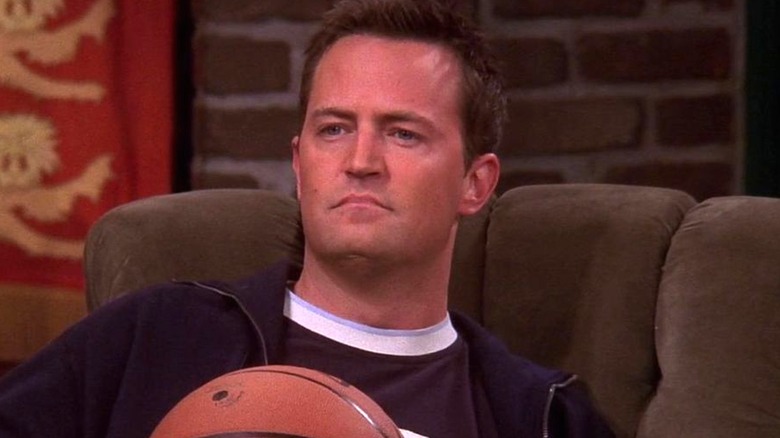 Chandler looks upward angry