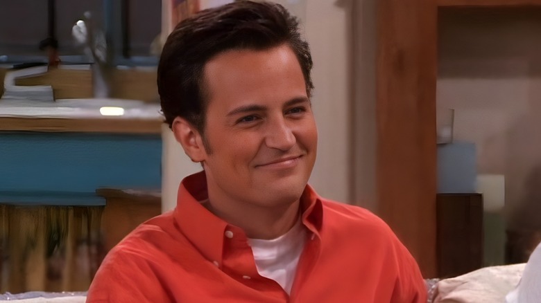 Chandler Bing closed mouth smile to the right