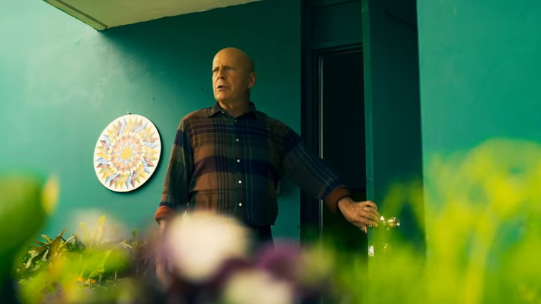 Bruce Willis walks out door