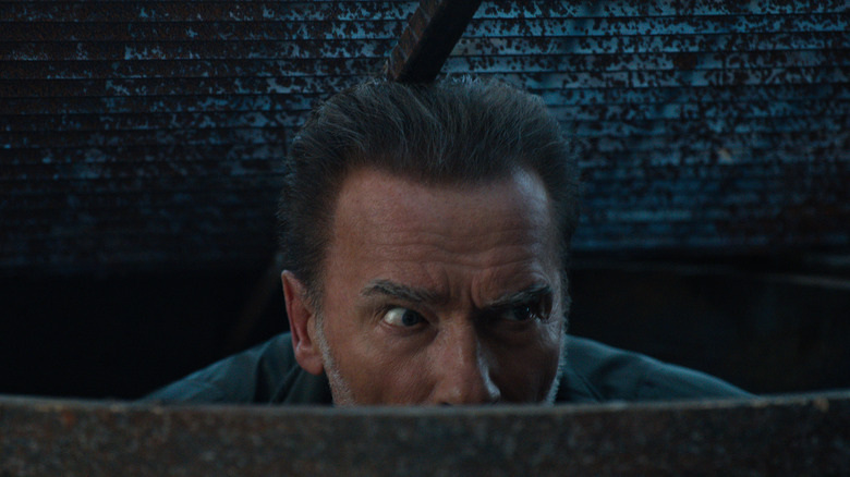 Arnold Schwarzenegger hiding in a drain