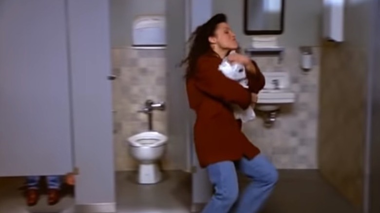 elaine running with toilet paper
