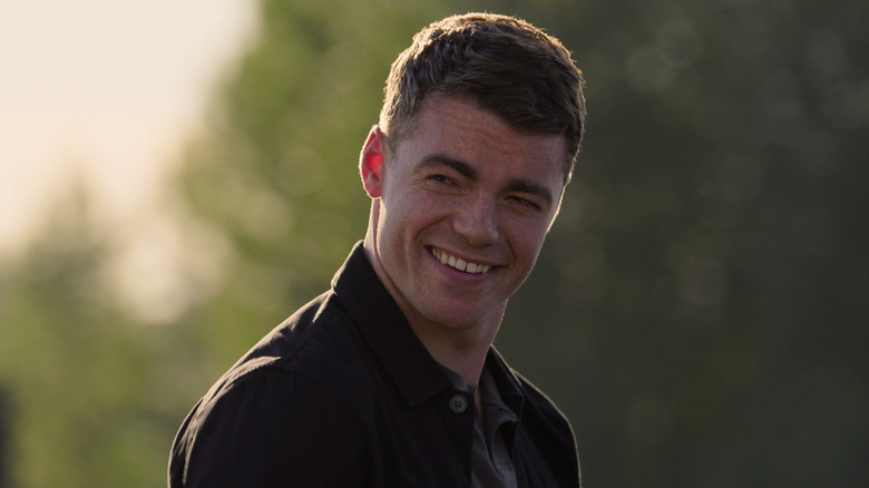 Peter Sutherland smiling, wearing black shirt