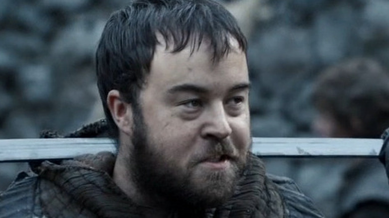 Rast holds a sword
