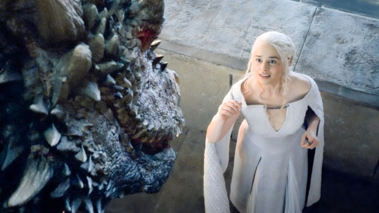 Daenerys Targaryen looking up at a dragon