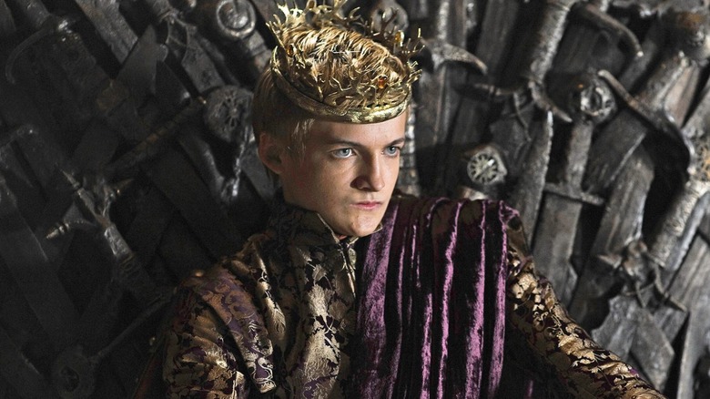 Jack Gleeson as Joffrey Baratheon sitting on the Iron Throne