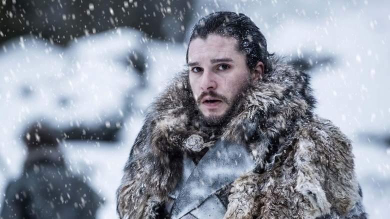 Jon Snow standing outside in a snowstorm