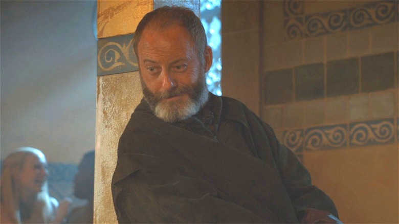 Ser Davos leaning and smiling 