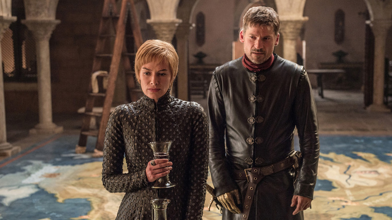 Jaime and Cersei standing on map