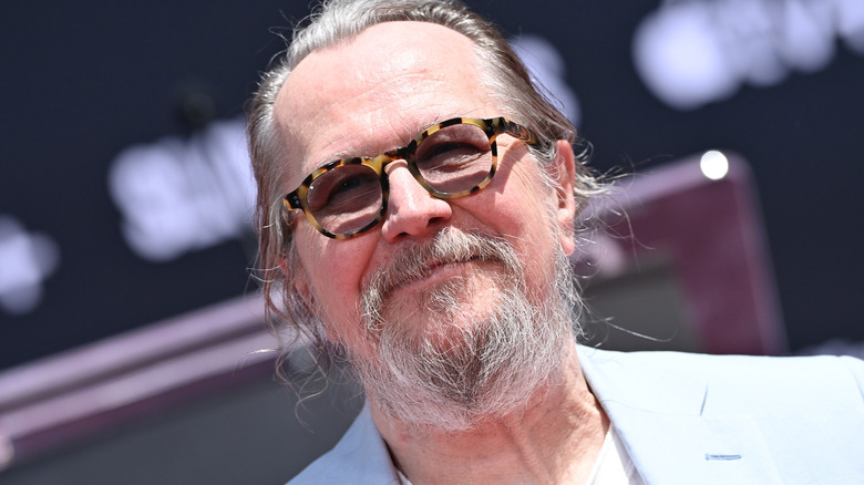 Gary Oldman smiling at his hand and footprint ceremony in 2025