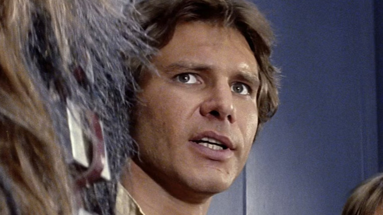 Han Solo assesses the situation next to Chewbacca in 