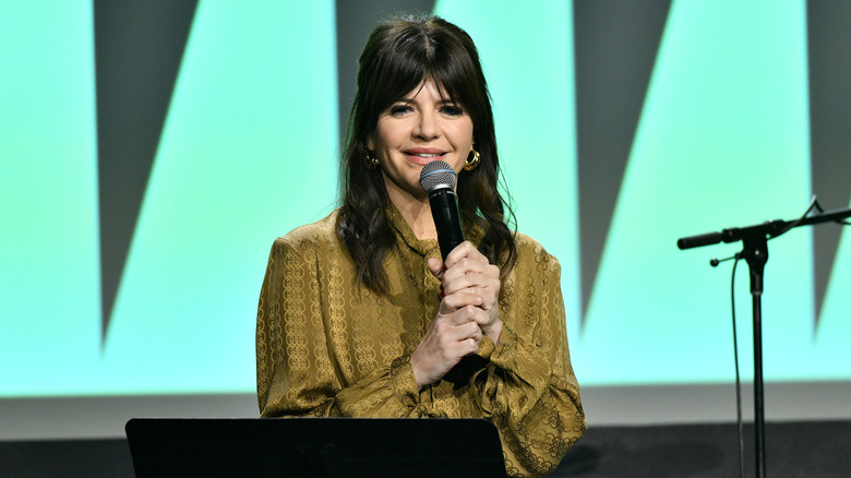 Casey Wilson talking into a microphone