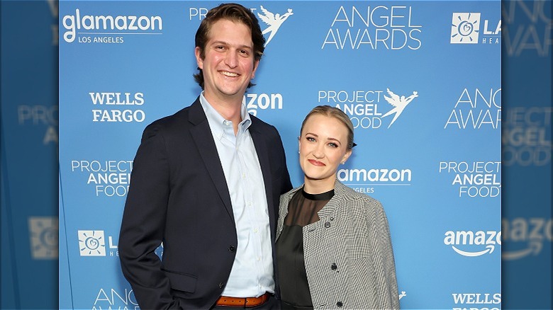 Emily Osment and Jack Anthony smiling on the red carpet