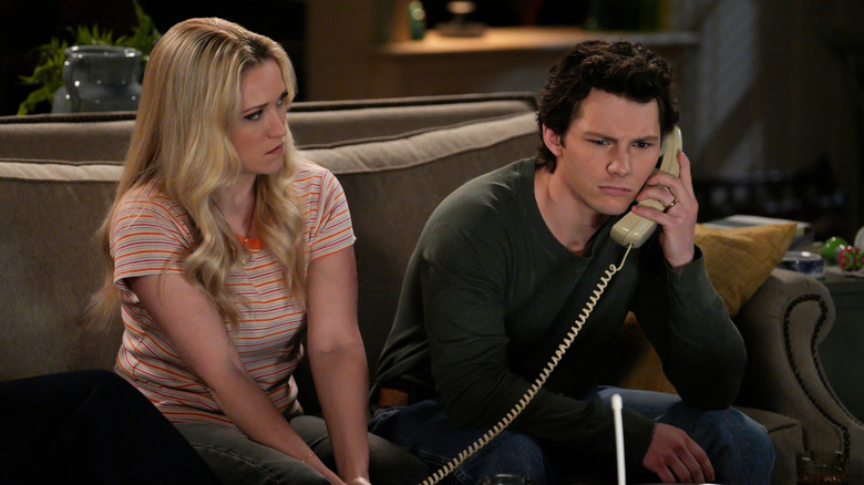 Georgie on phone as Mandy looks on concerned