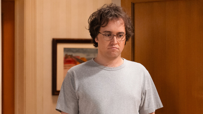 Connor pouts in the doorway in 