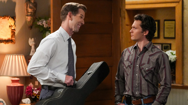 Pastor Jeff Difford holds his guitar case while talking to Georgie in "Georgie and Mandy's First Marriage"