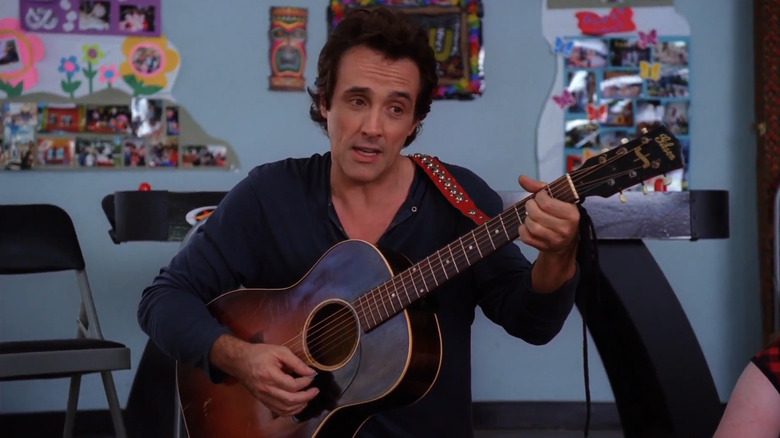 Reverend Tim-Tom plays his guitar in "The Middle"