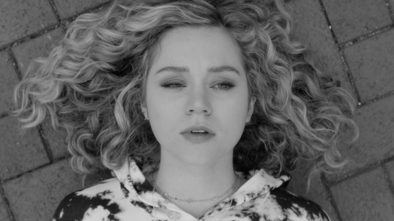 ECU of Brec Bassinger as Stargirl black and white on bricks